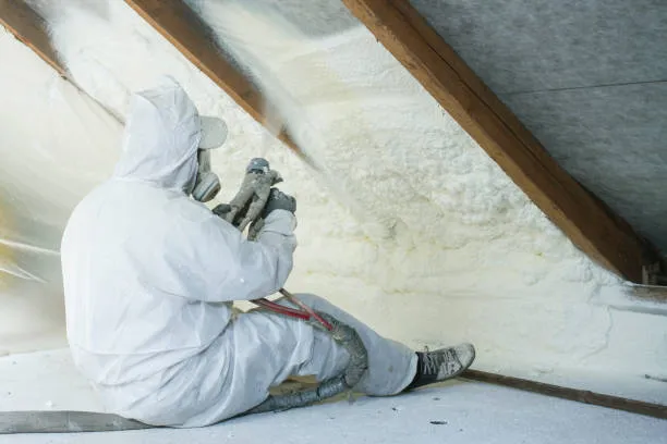 spray foam insulation nyc technician spraying while sitting